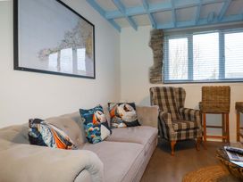 A living room with a sofa and armchair at Puffin Cottage in Tintagel