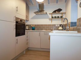 A kitchen with cabinets and a sink at Puffin Cottage in Tintagel