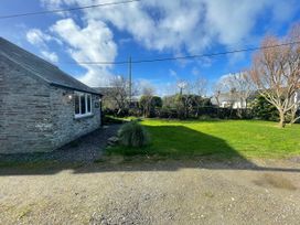 An outdoor view of a house and garden at Puffin Cottage in Tintagel