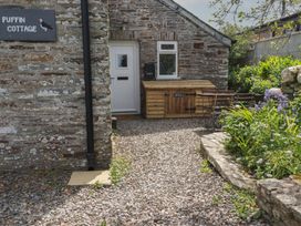 An outdoor area with a door and seating at Puffin Cottage in Tintagel