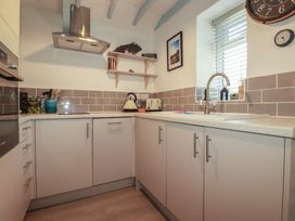A kitchen with a sink and kettle at Puffin Cottage in Tintagel