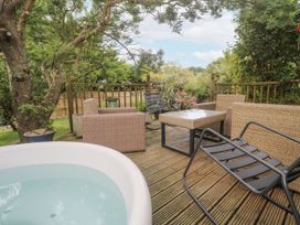 A garden with a hot tub and outdoor seating at 6 The Links Praa Sands