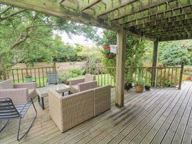 A garden with outdoor furniture on a deck at 6 The Links Praa Sands