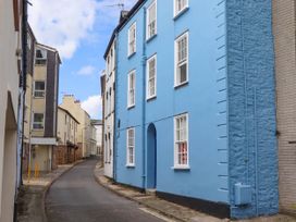 A narrow street with buildings on both sides including a blue building on the right side at Harbour Hideaway in Dartmouth