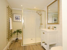 A bathroom with a walk in shower vanity with mirror and a plant at Holmer House Farm in Holmer near Hereford
