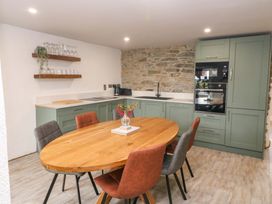 A kitchen with a dining table and chairs at Valley View House Kealkill County Cork