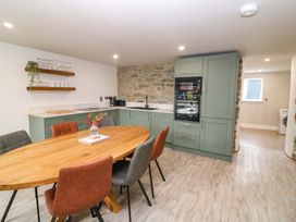 A kitchen with a wooden table and chairs at Valley View House in Kealkill, County Cork