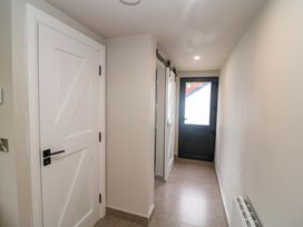 A hallway with doors and light fixtures at Valley View House in Kealkill, County Cork