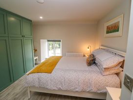 A bedroom with a bed and wardrobe at Valley View House in Kealkill, County Cork