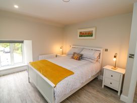 A bedroom with a bed and nightstand at Valley View House in Kealkill, County Cork
