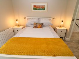 A bedroom with a bed and bedside tables at Valley View House in Kealkill, County Cork