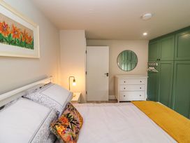 A bedroom with a bed and dresser at Valley View House in Kealkill, County Cork