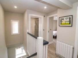 A hallway with a staircase and a shower door at Valley View House in Kealkill, County Cork