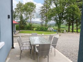 An outdoor dining set with a table and chairs at Valley View House, Kealkill, County Cork