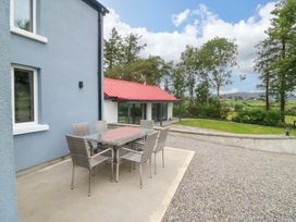 An outdoor seating area with a table and chairs at Valley View House in Kealkill, County Cork
