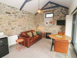 A living room with a sofa and dining table at The Stall near Kealkill, County Cork