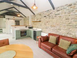 A kitchen with a dining area and a sofa at The Stall near Kealkill, County Cork