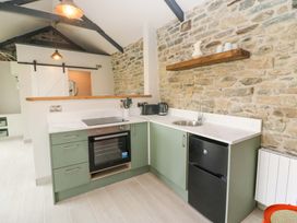 A kitchen with cabinets and appliances at The Stall near Kealkill, County Cork