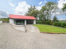 A house with a red roof and lawn at The Stall near Kealkill, County Cork
