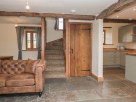 A living room with a couch and stairs at Howgill Head in Kendal