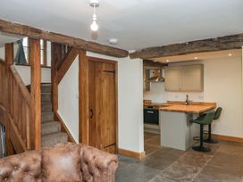 A kitchen with stairs and bar stools at Howgill Head in Kendal