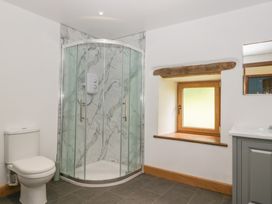 A bathroom with a shower, toilet, and sink at Howgill Head in Kendal
