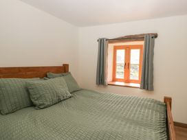 A bedroom with a bed and a window at Howgill Head in Kendal