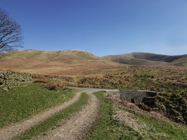 A dirt path leading through hills at Howgill Head in Kendal