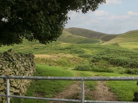 A gate leading to hills and grassland at Howgill Head in Kendal