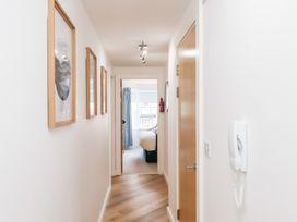 A hallway with framed pictures and a door at Belle's View in Scarborough