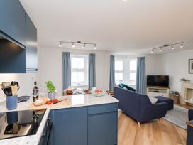 A kitchen and living room with a TV and couch at Belle's View in Scarborough