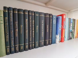 A shelf with various books at Belle's View Scarborough