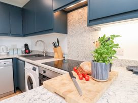 A kitchen with a cutting board and vegetables at Belle's View in Scarborough