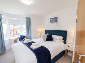 A bedroom with a bed and bedside table at Belle's View in Scarborough