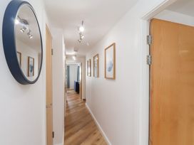 A hallway with a mirror and framed artwork at Belle's View in Scarborough