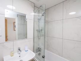 A bathroom with a shower and bathtub at Belle's View in Scarborough