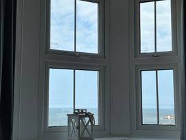 A window with an ocean view and a lantern at Belle's View in Scarborough