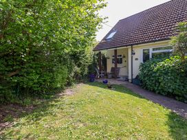 A garden with a house and trees at Rosemarie Annexe in Axminster