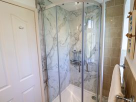 A shower enclosure with glass doors in Rosemarie Annexe Axminster