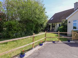 A house with a garden and fence at Rosemarie Annexe in Axminster