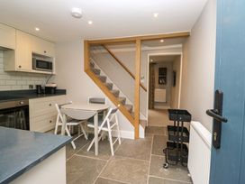 A kitchen with chairs and a table at Dove Cottage Ambleside