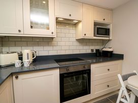 A kitchen with a microwave and a toaster at Dove Cottage Ambleside