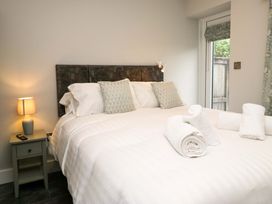 A bedroom with a bed and towels at Dove Cottage in Ambleside