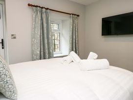 A bedroom with a bed and towels arranged on it at Dove Cottage in Ambleside
