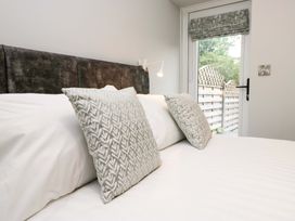 A bed with pillows and a window in a bedroom at Dove Cottage in Ambleside