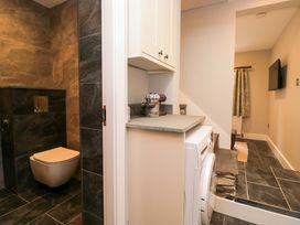 A bathroom with a toilet and washing machine at Dove Cottage in Ambleside
