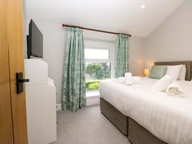 A bedroom with a bed and television at Dove Cottage in Ambleside