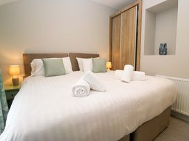 A bedroom with a bed and lamps at Dove Cottage in Ambleside