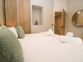 A bedroom with a bed and decorative pillows at Dove Cottage in Ambleside