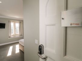 A bedroom with a door and window at Harcombe Heights in Chudleigh